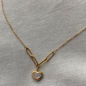 Super cute gold necklace with dainty iridescent heart charm. Great quality.